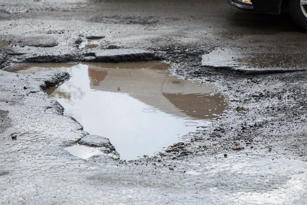 parking lot potholes, parking lot maintenance, pothole, pothole patchwork, asphalt maintenance
