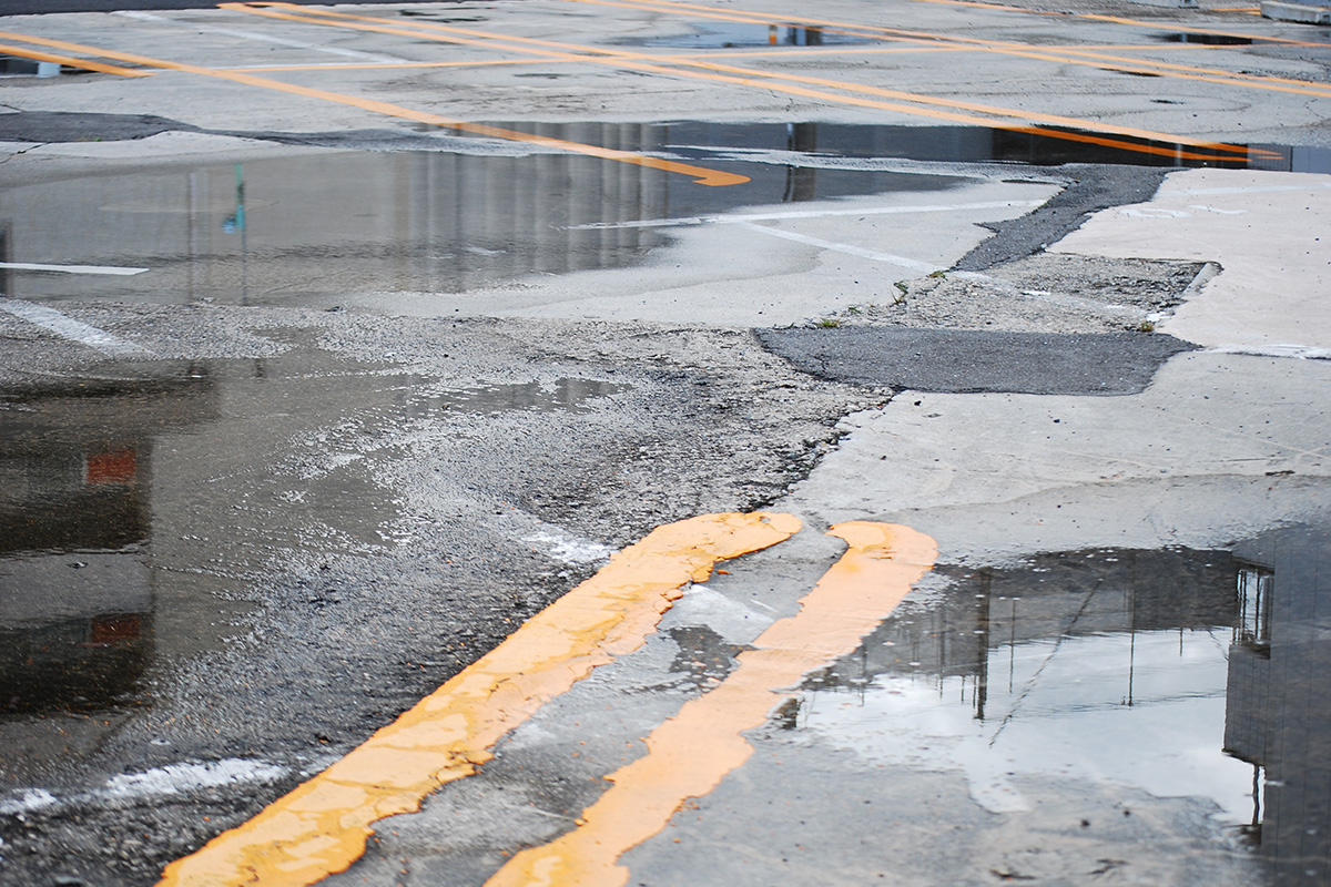 Baughman Magic Seal, parking lot water, standing water parking lot, parking lot asphalt services, parking lot sealcoating, asphalt repair, parking lot repair